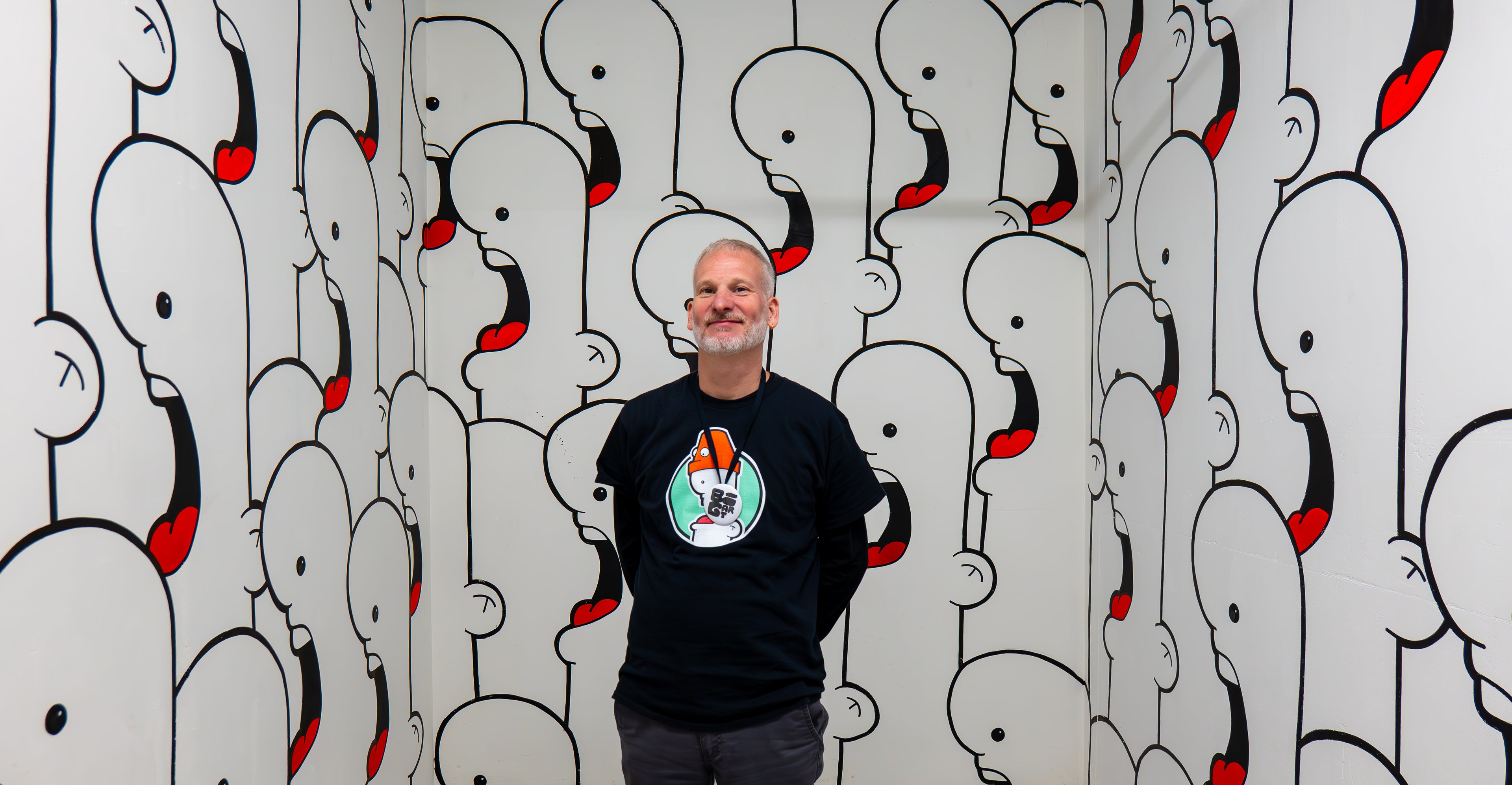 Ran Kunst in front of his mural he created for bigart 2026 - that's just like your opinion