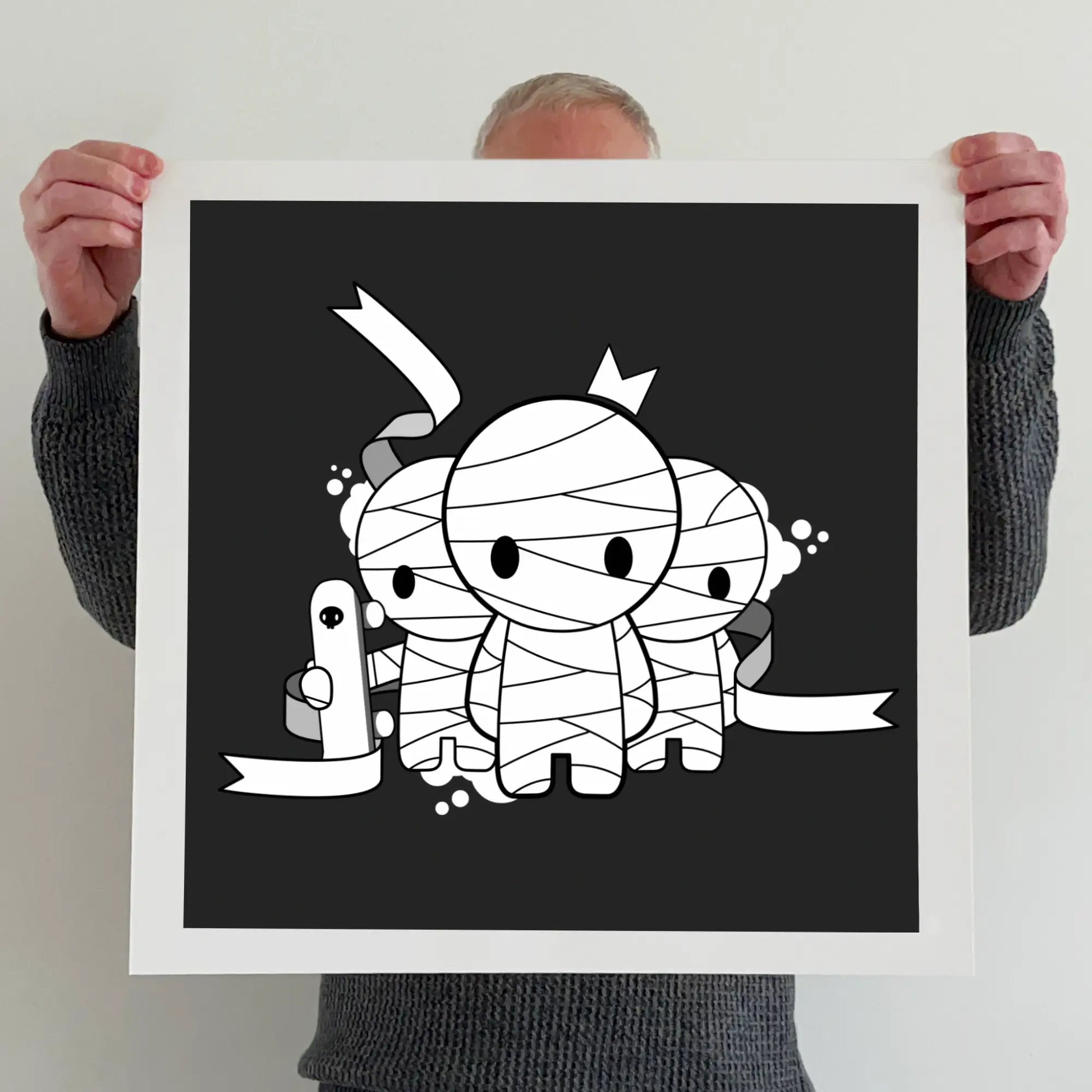 Ran holding a "Mummies with skateboards" print 