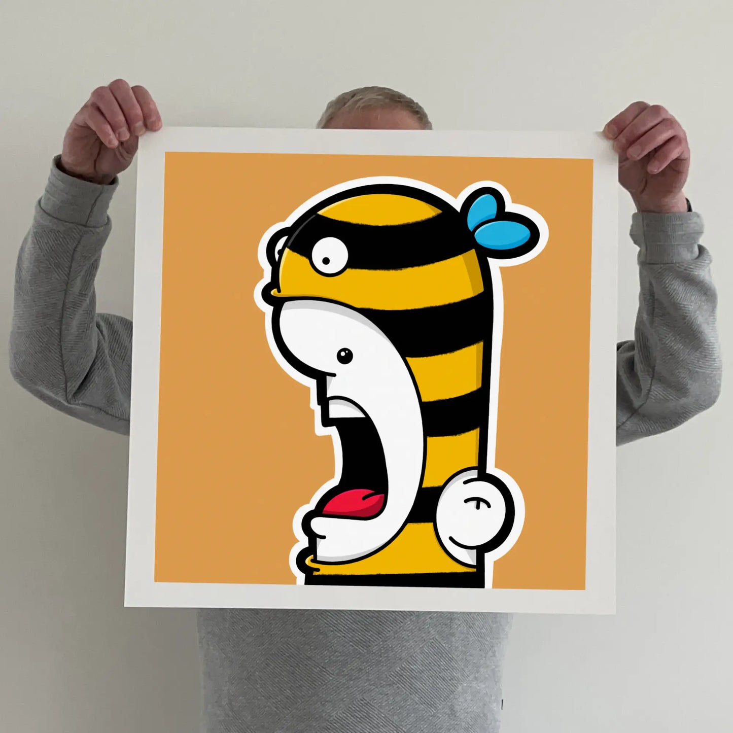 Ran holding a "shouter vs bee" print 