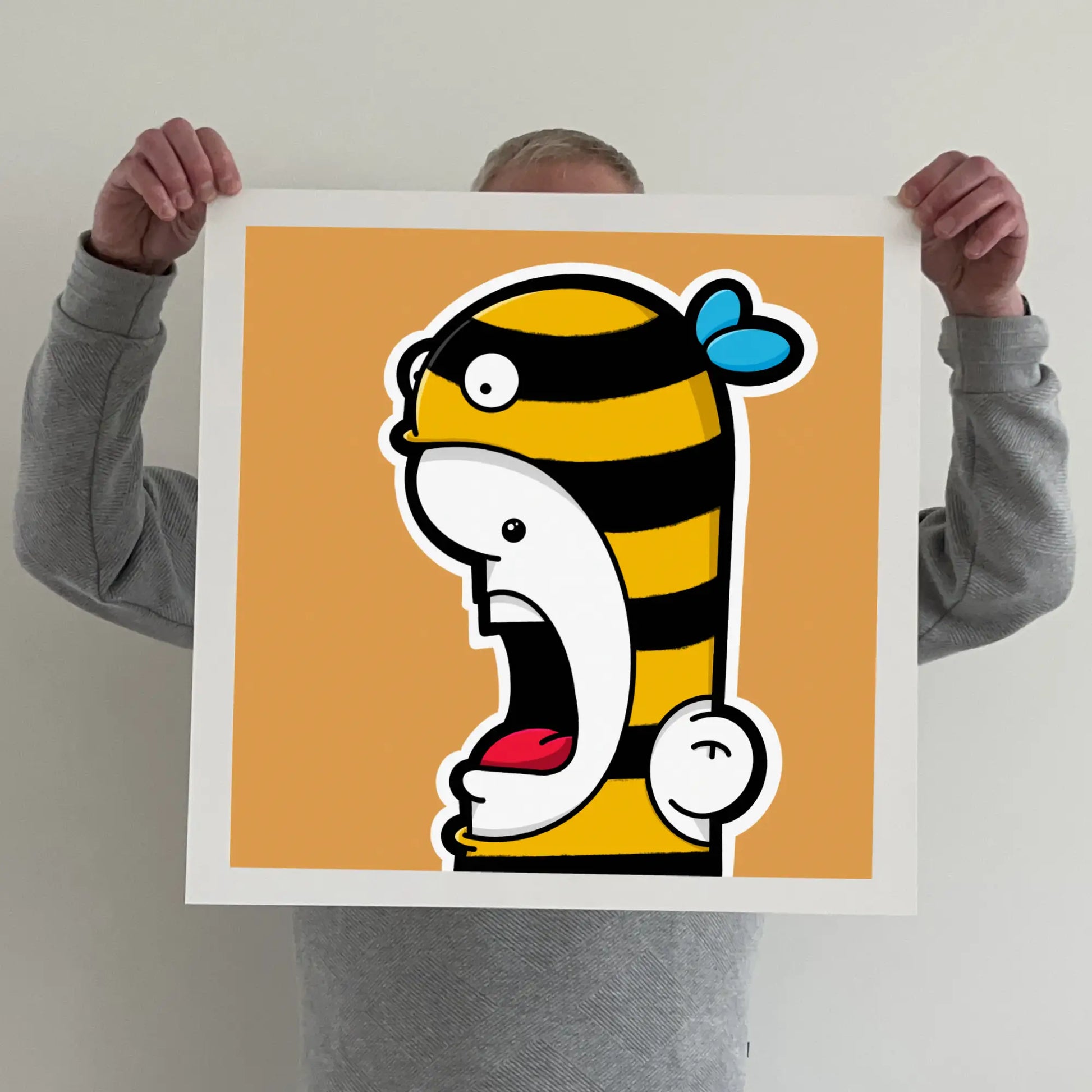 Ran holding a "shouter vs bee" print 