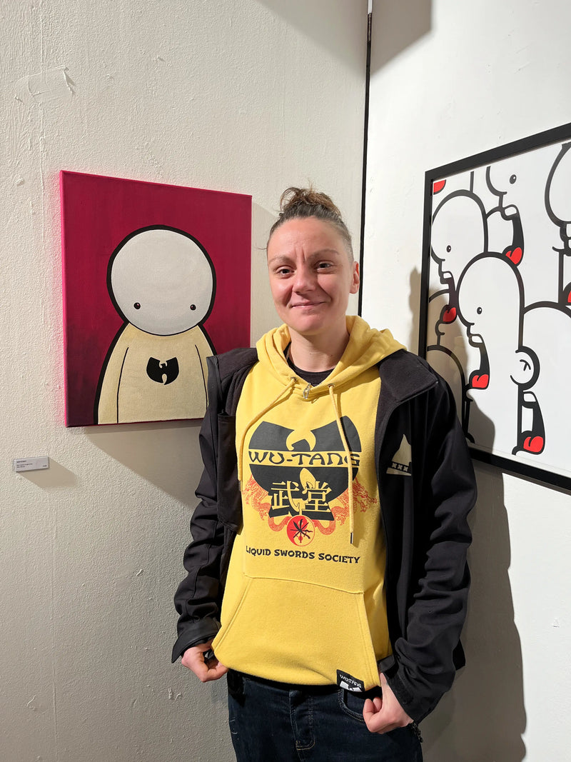 When art meets real life. A visitor at the Vrijpaleis in Amsterdam wearing a wu-tang hoodie admires the Wu-tang forever painting by Ran Kunst